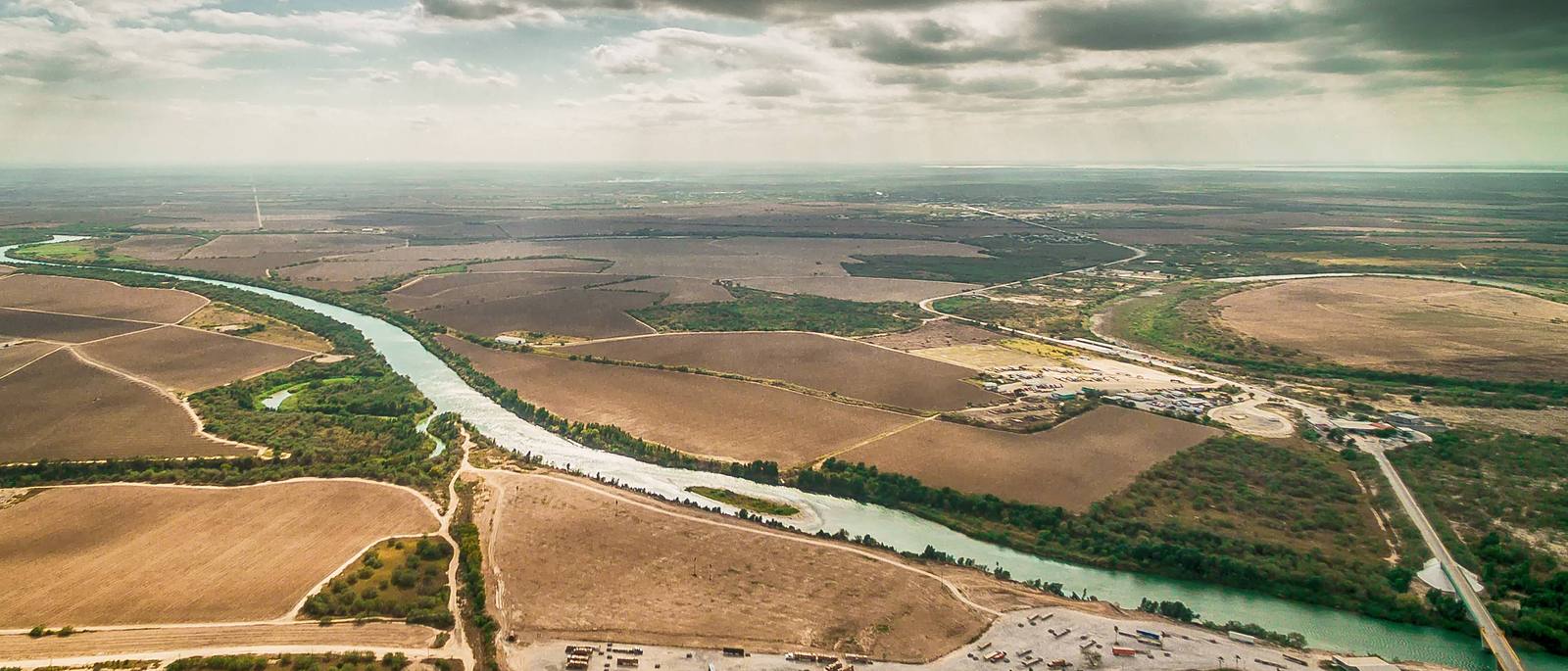 The Rio Grande from the air, winding between farmland on both sides of the border.